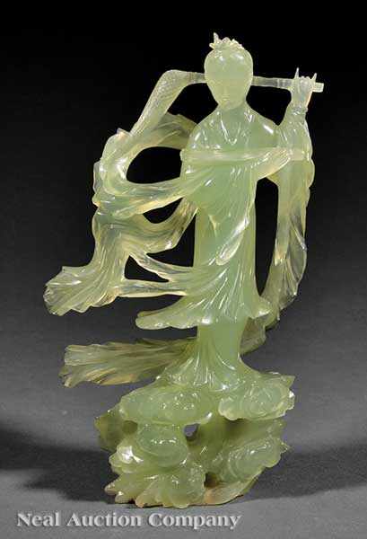 Appraisal: A Chinese Carved Green Hardstone Figure of Guanyin th c