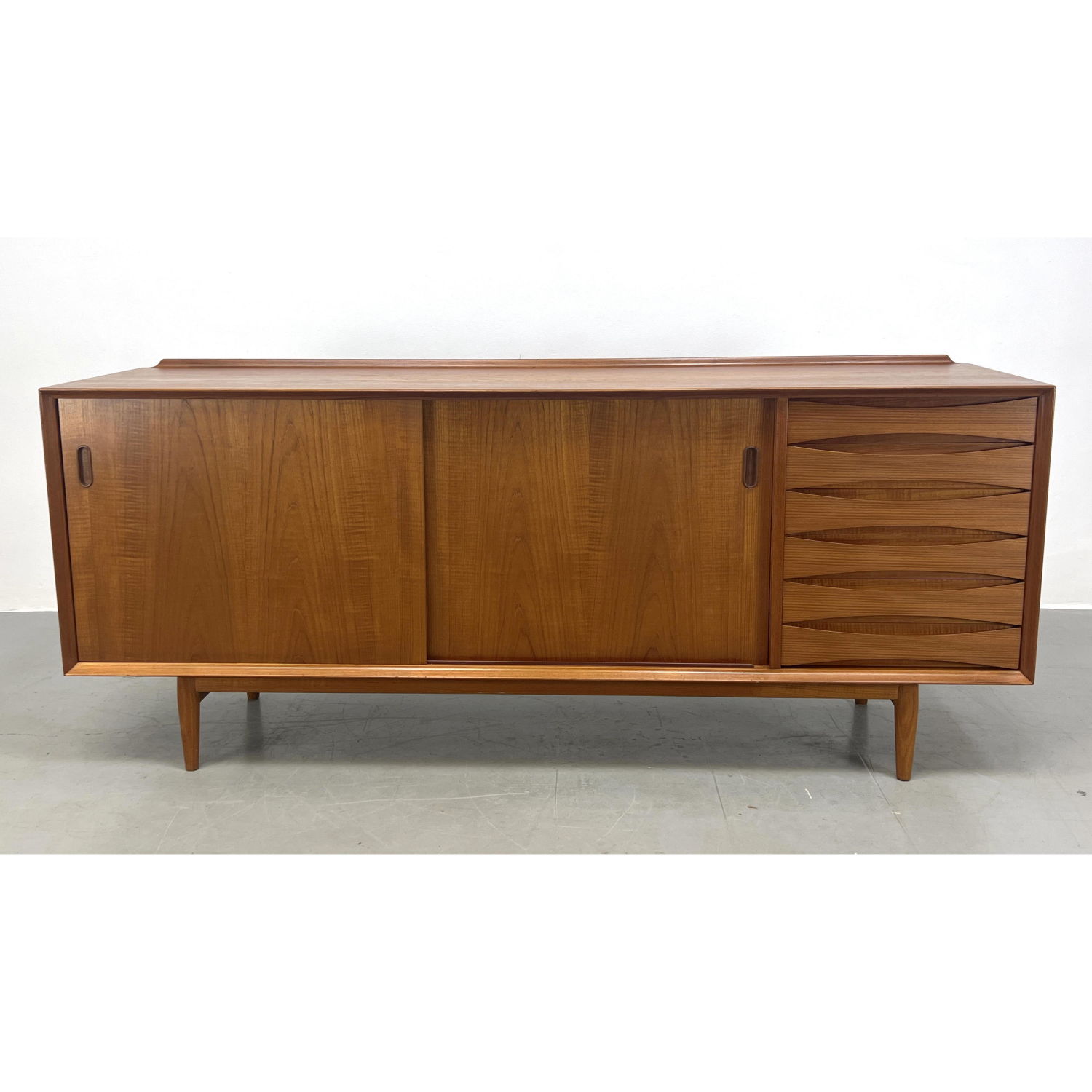 Appraisal: Arne Vodder teak credenza with reversible sliding doors Signed Sibast