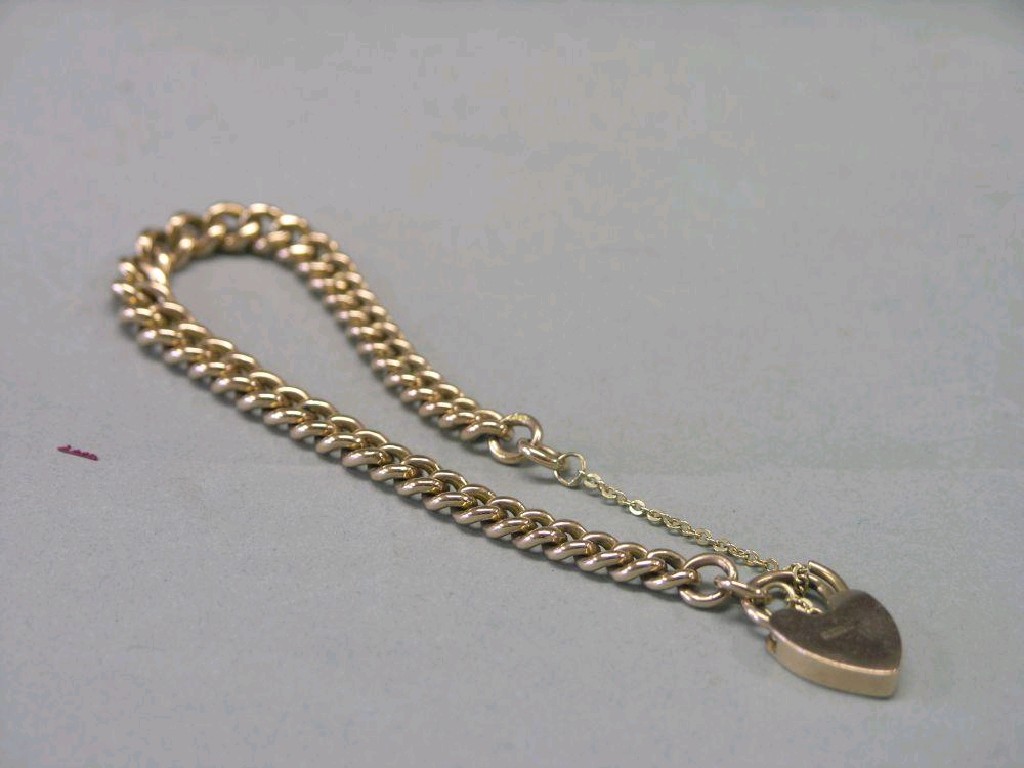 Appraisal: A ct gold link bracelet with heart shape padlock pendant