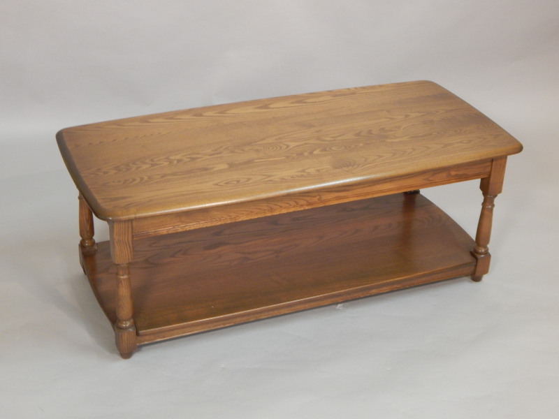 Appraisal: An Ercol elm two tier coffee table the shaped top