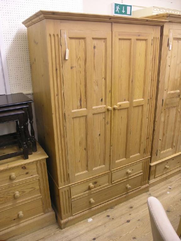 Appraisal: A modern waxed pine lady's wardrobe pair of panelled doors