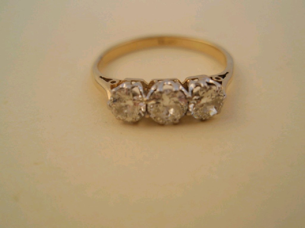 Appraisal: A three stone diamond ring set in yellow metal stamped