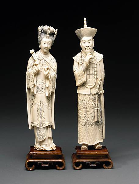 Appraisal: A pair of tinted ivory emperor and empress figures th