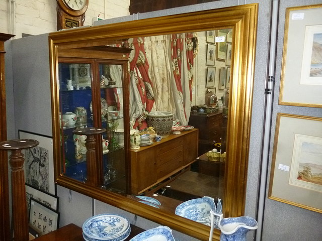 Appraisal: A LARGE RECTANGULAR GILT FRAMED MIRROR with bevelled plate approximately