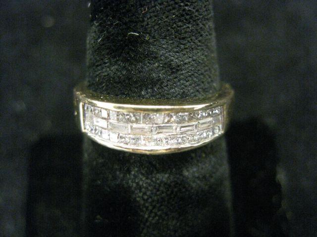 Appraisal: Diamond Ring a center row of invisible set straight baguette