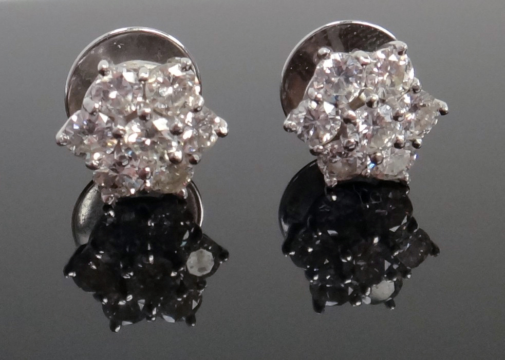 Appraisal: A pair of diamond set seven stone cluster earstuds each