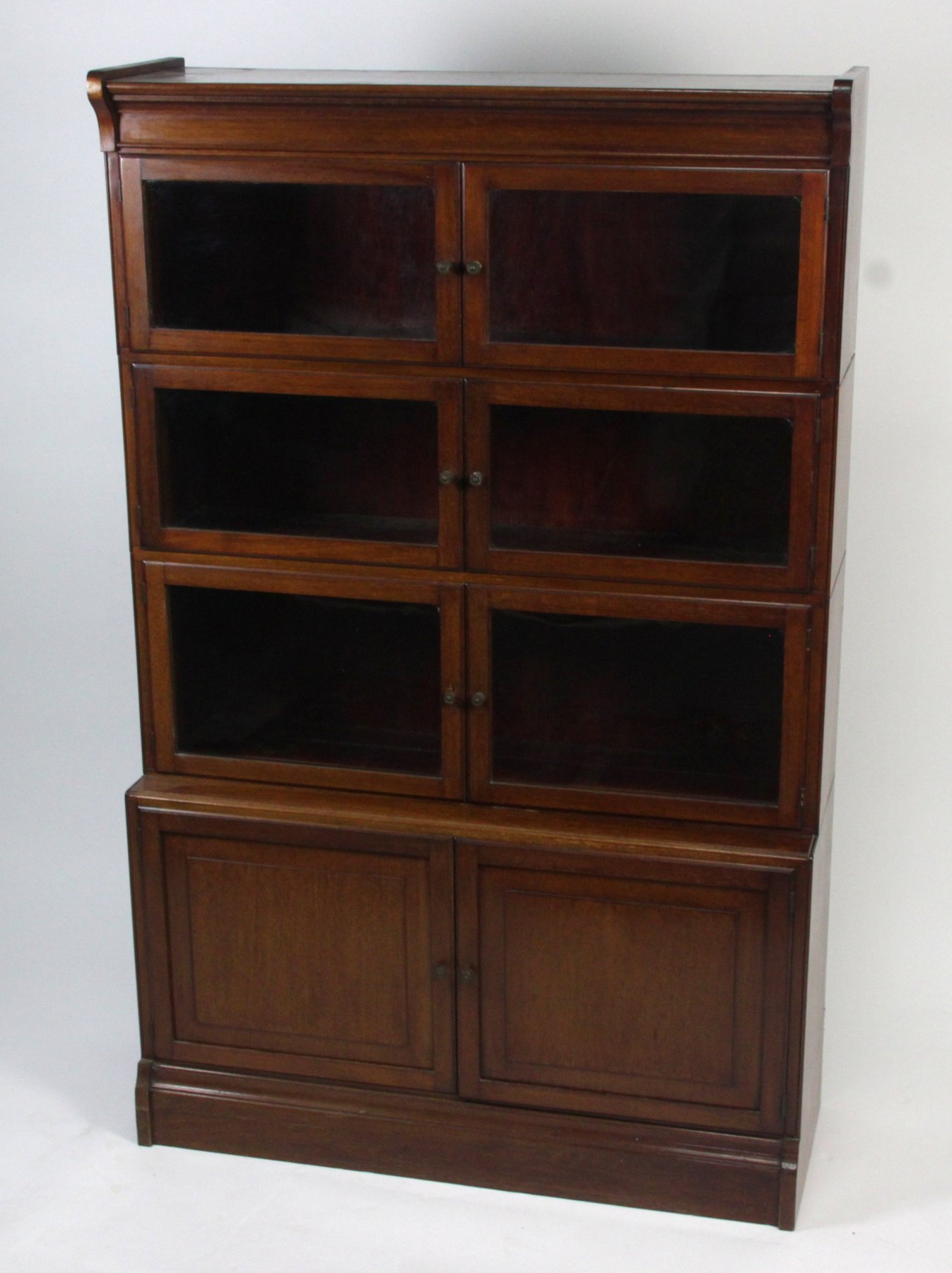 Appraisal: A mahogany glass fronted bookcase with panelled doors below cm