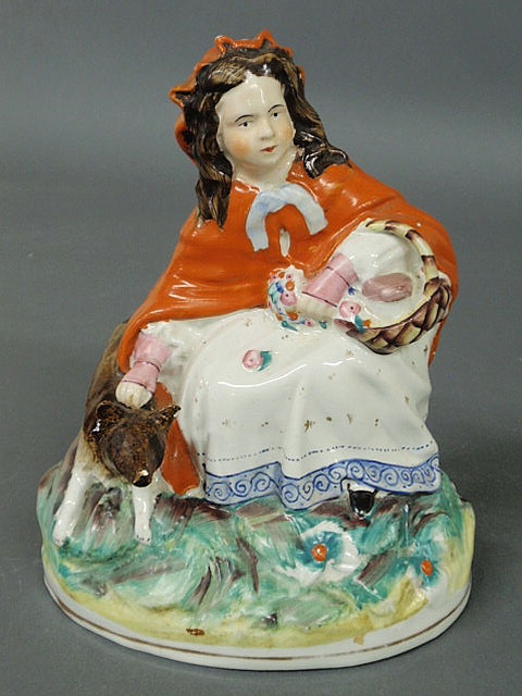 Appraisal: Staffordshire figure of a seated Little Red Riding Hood with