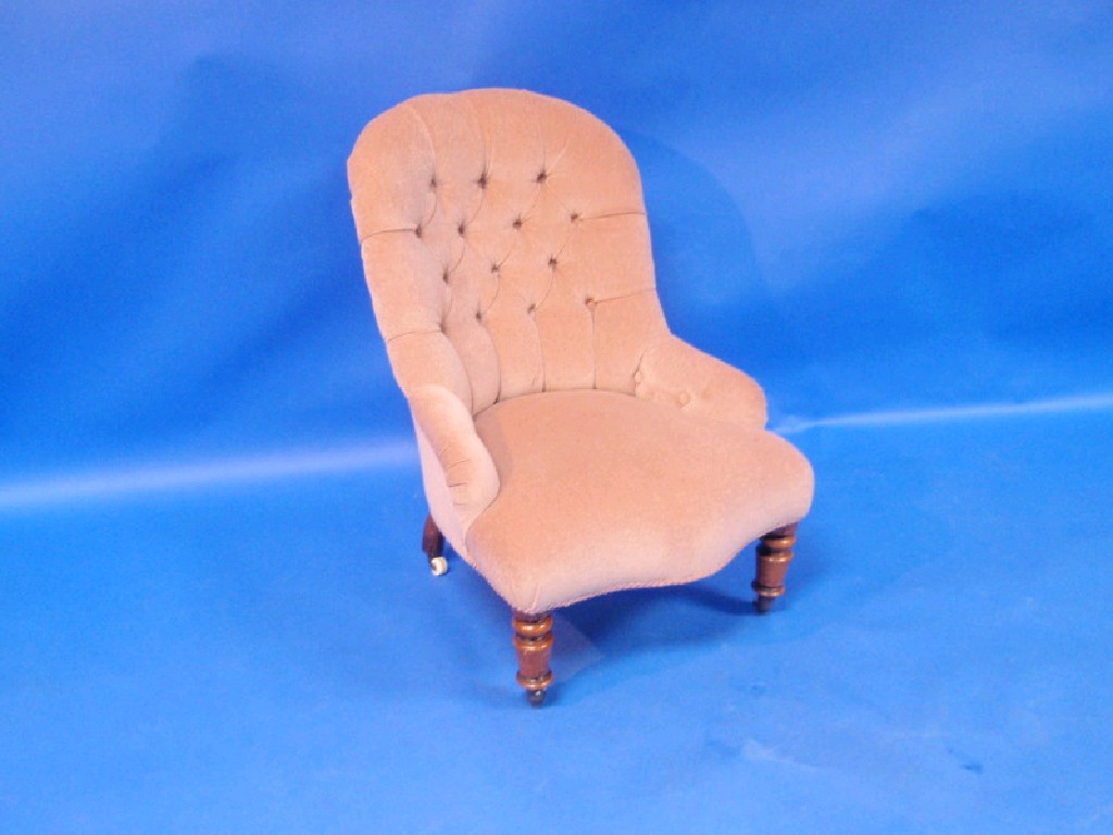 Appraisal: A Victorian button-back low-seated upholstered chair turned support and castors