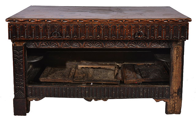 Appraisal: AN OAK SIDE TABLE with carved frieze drawers and further