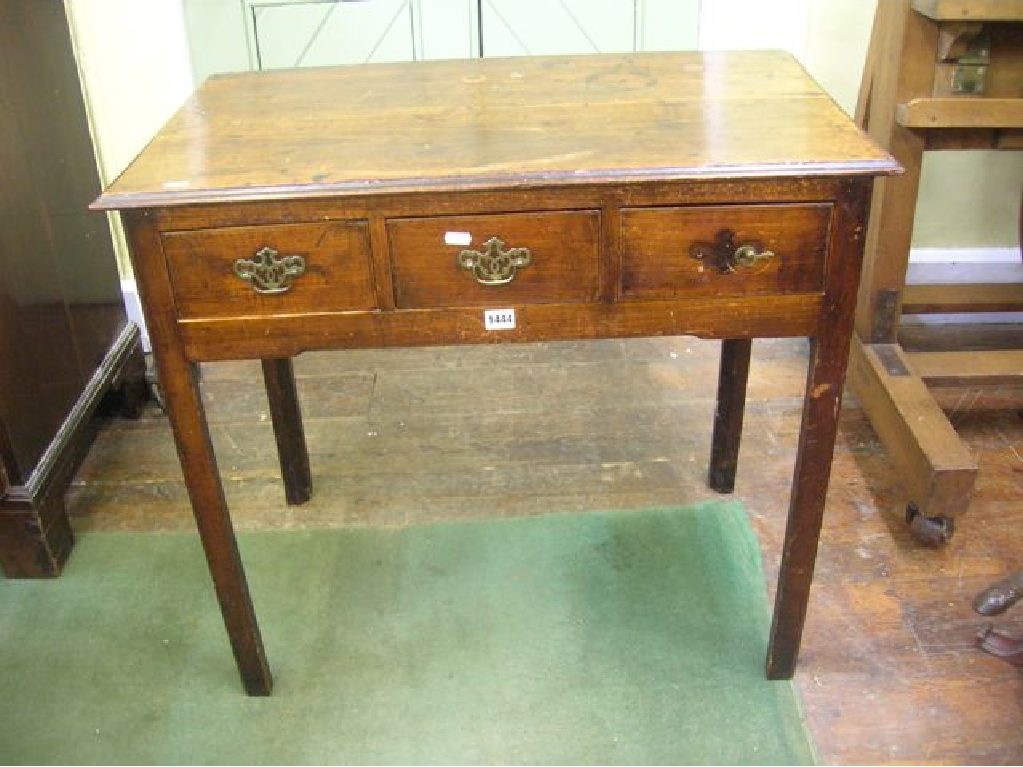 Appraisal: A Georgian country made fruitwood side table fitted with three