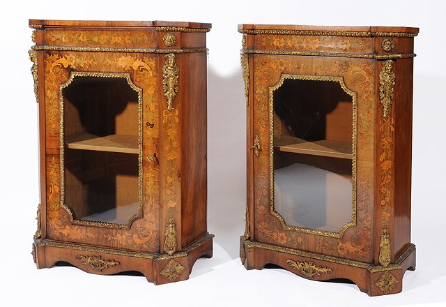 Appraisal: A PAIR OF VICTORIAN WALNUT PIER CABINETS with marquetry floral