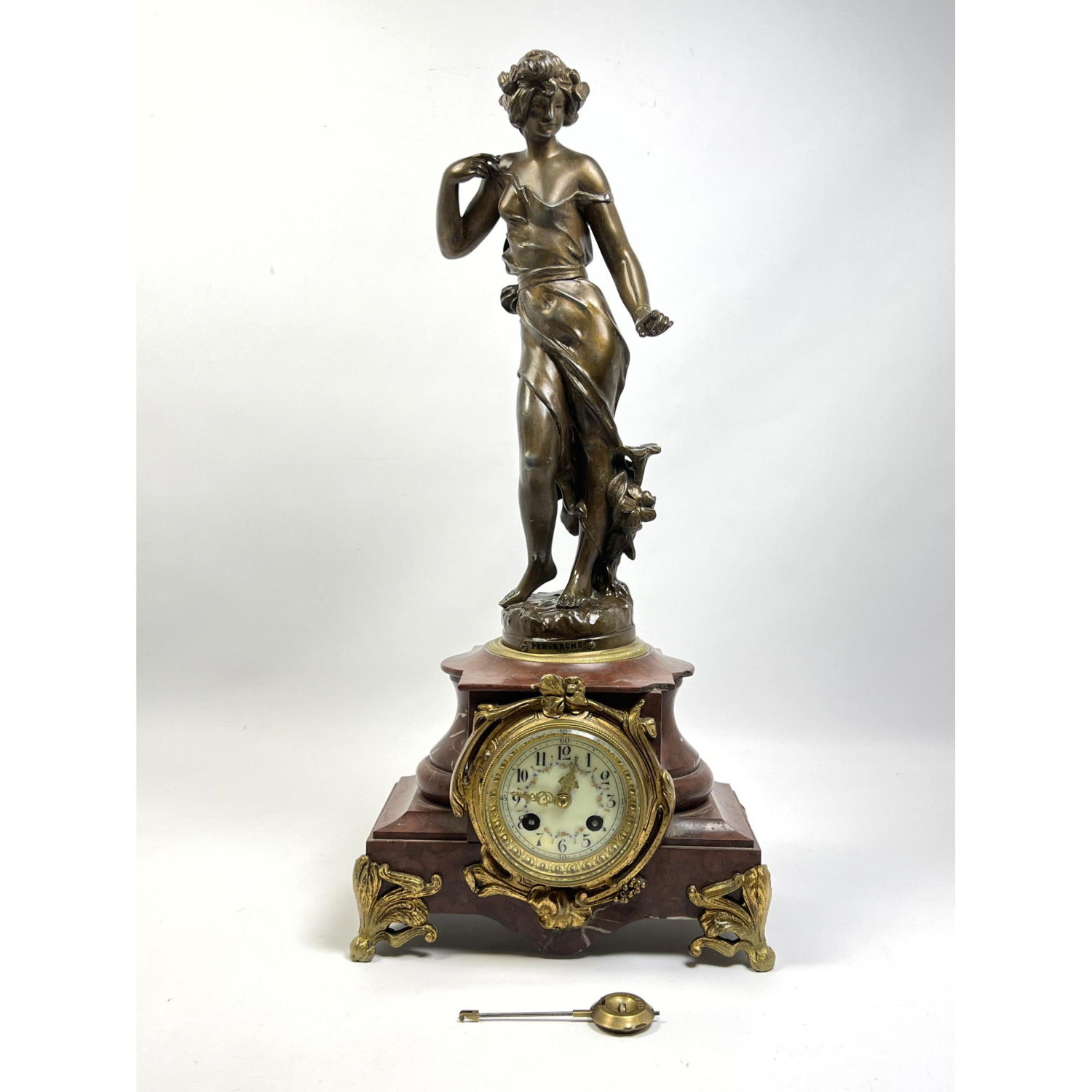 Appraisal: Red Marble French Sculpture Mantle Clock Figural female mounted on