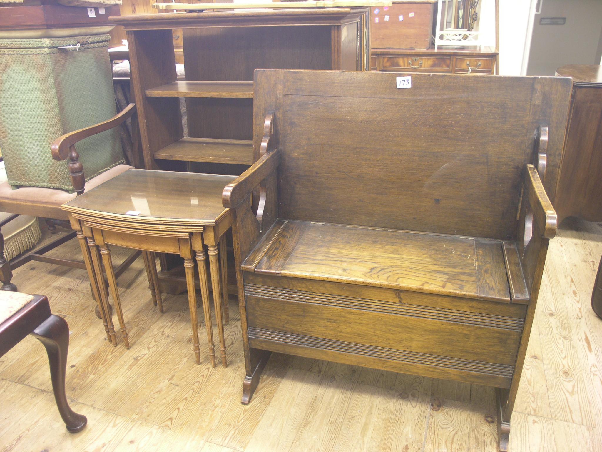 Appraisal: An oak open bookcase a nest of three tables and