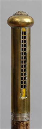 Appraisal: ENGLISH WALNUT WALKING STICK WITH BRASS HARMONICA HANDLE The cylindrical