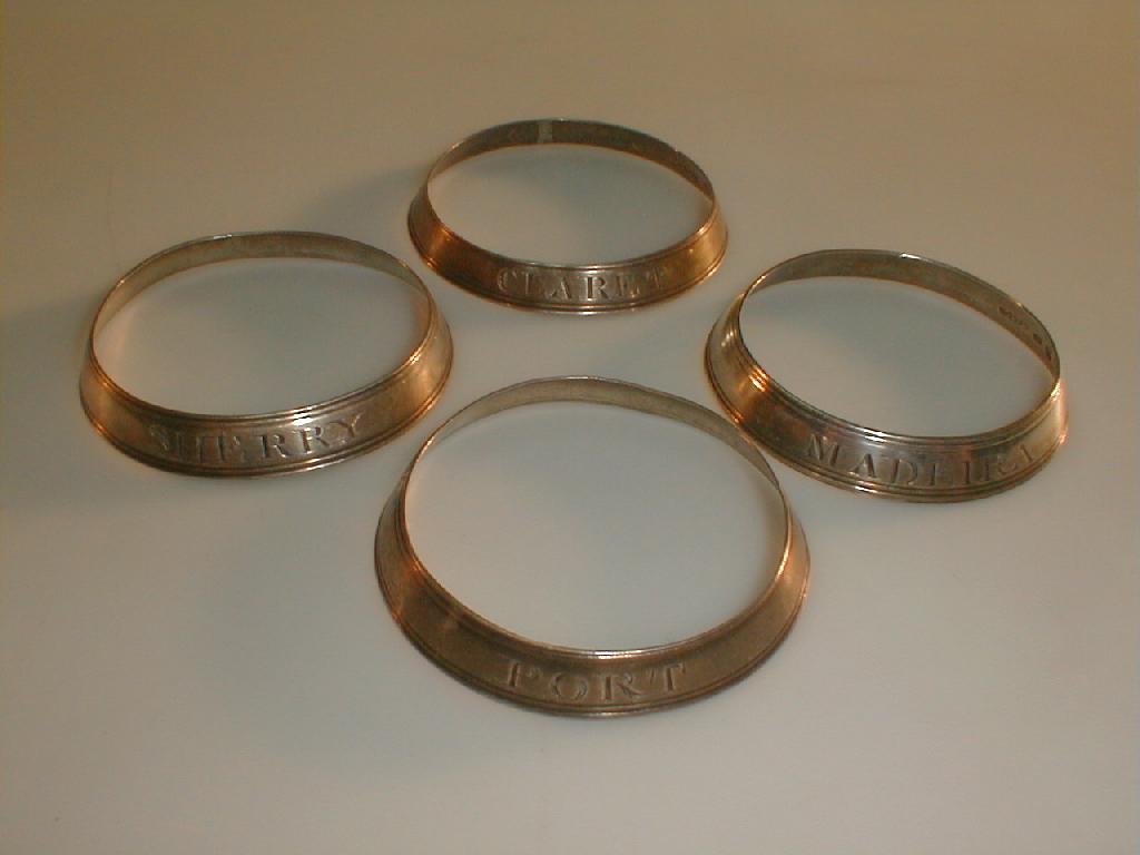 Appraisal: A set of four George III silver decanter collars inscribed