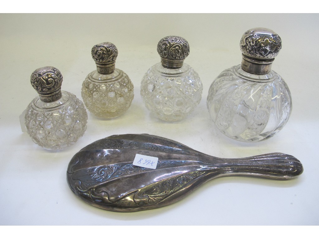 Appraisal: A lot comprising a pair of silver topped scent bottles