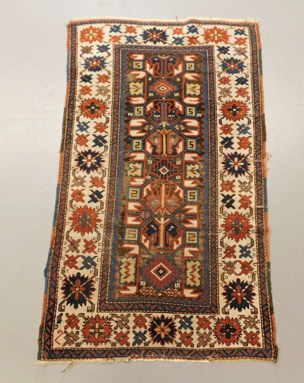 Appraisal: ANTIQUE GEOMETRIC KAZAK CARPET Middle East Circa Blue red tan