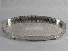 Appraisal: A silver oval tray on four feet with gadrooned and