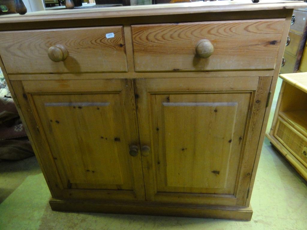 Appraisal: A stripped pine side cupboard dresser base fitted with two