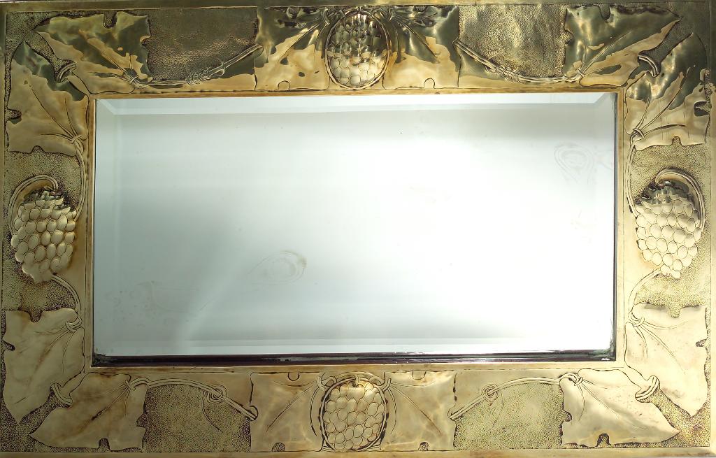 Appraisal: GLASGOW SCHOOL ARTS AND CRAFTS BRASS-FRAMED MIRROR the rectangular plate