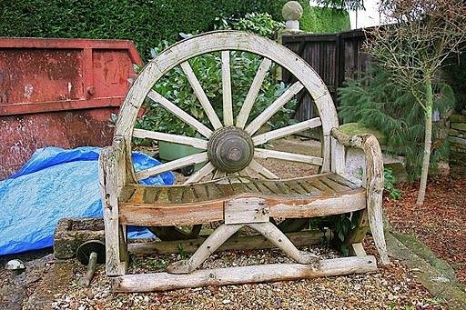 Appraisal: A small rustic bench with cartwheel back cm long cm