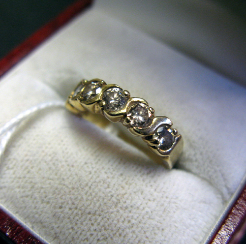 Appraisal: CHILD'S DIAMOND AND FOURTEEN KARAT GOLD RING set with six