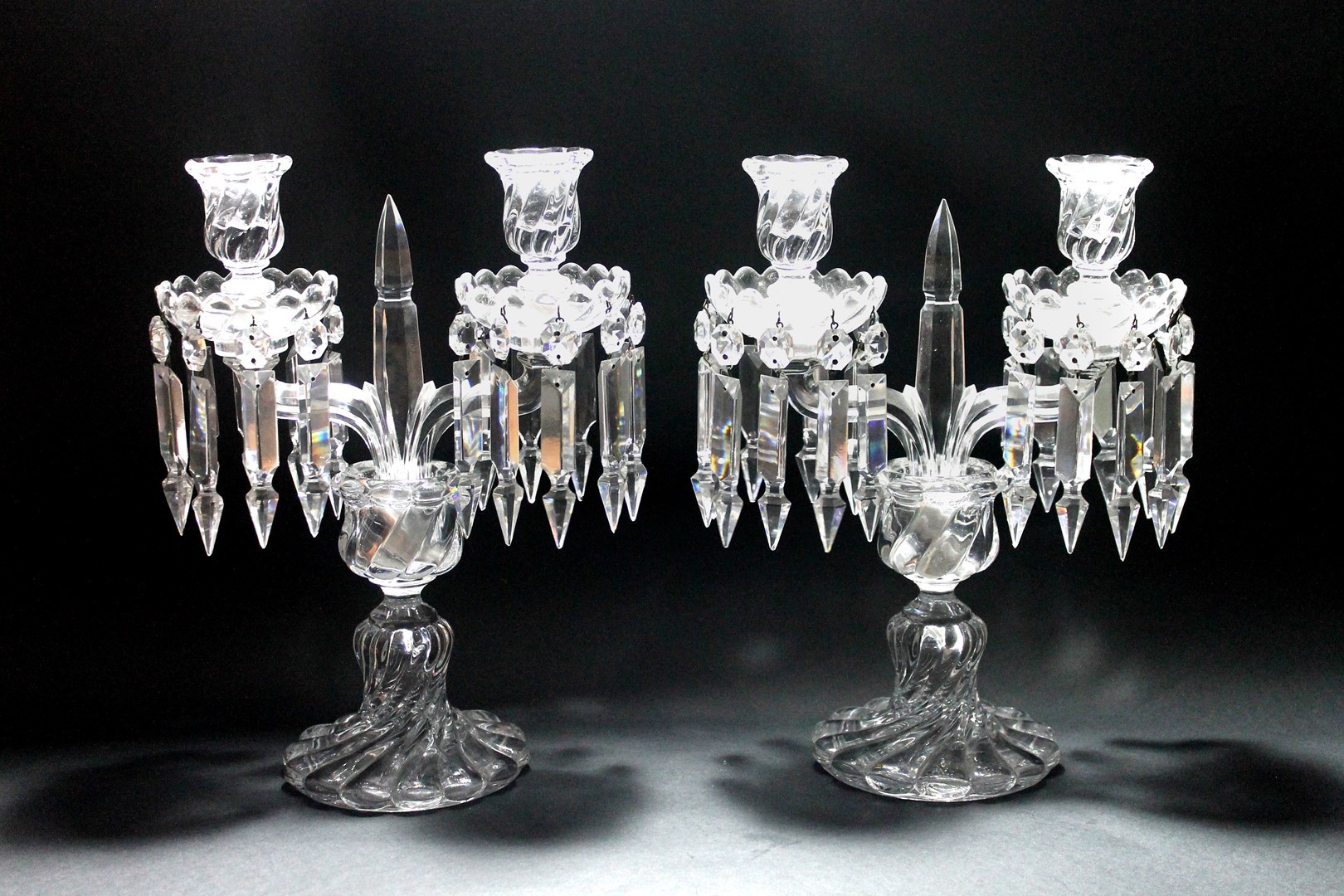 Appraisal: A pair of Baccarat glass twin branch candlestick lustres with