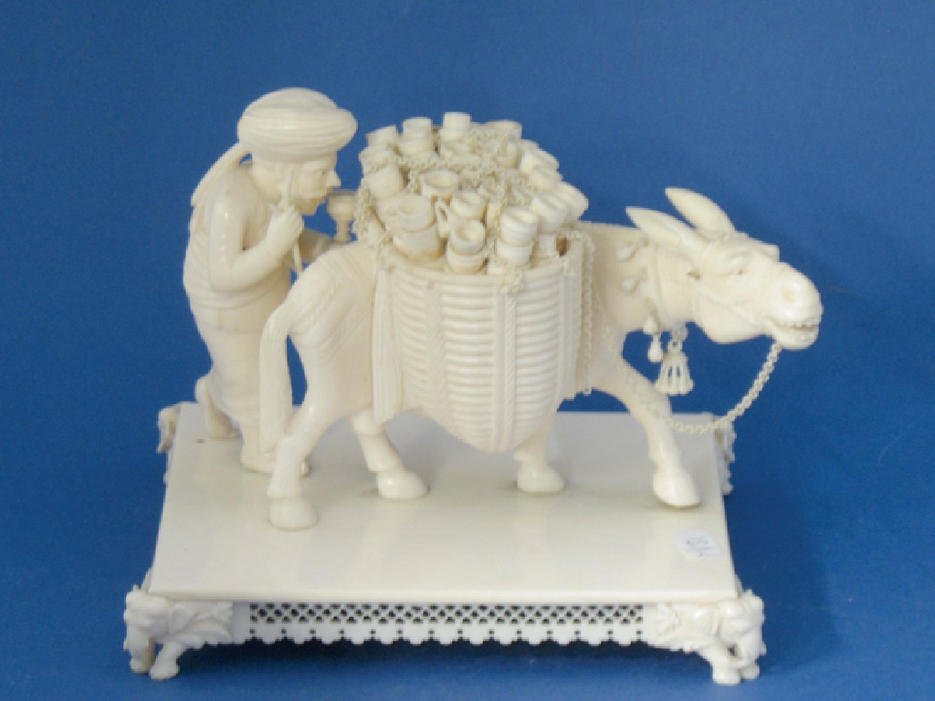 Appraisal: AN INDIAN IVORY GROUP of a man driving a mule