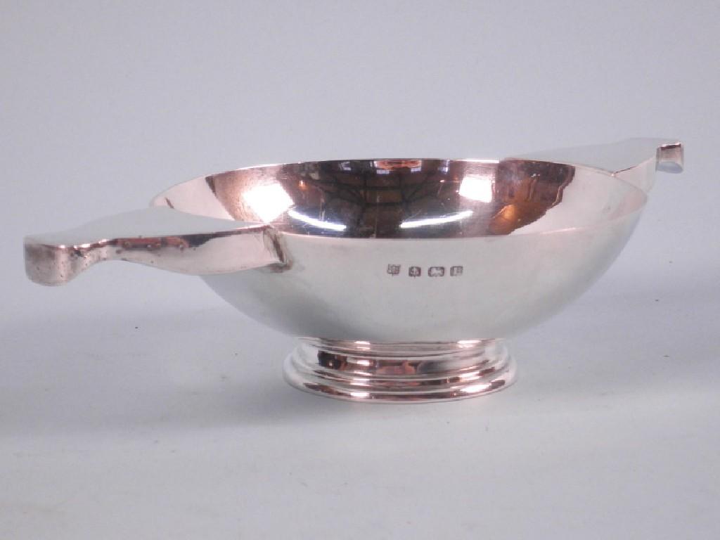 Appraisal: A silver two handled quaich with shaped handles and a