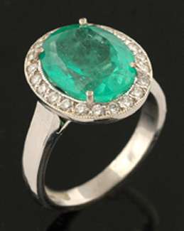 Appraisal: An emerald and diamond cluster ring The oval emerald of