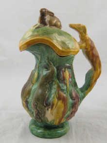 Appraisal: An unusual earthenware jug in flambe glaze over moulded hanging