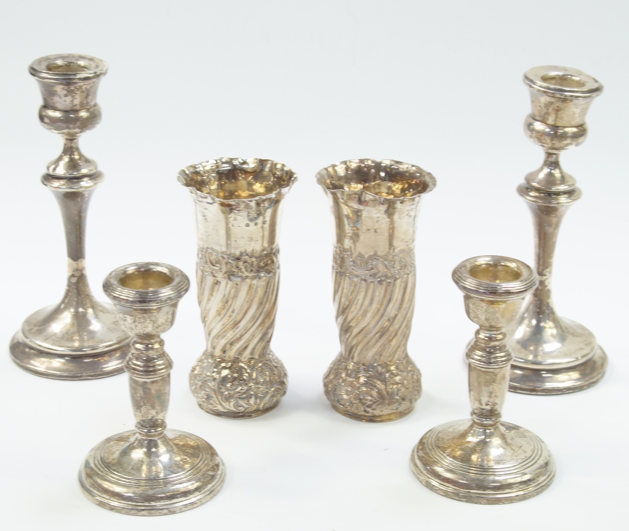 Appraisal: A pair of George V loaded silver candlesticks of baluster