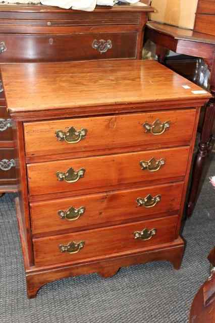 Appraisal: A SMALL PINE CHEST of four long drawers standing on