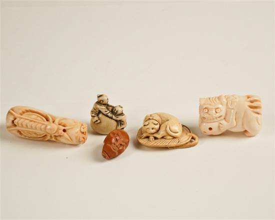 Appraisal: Five Small Asian Carvings an ivory netsuke in the form