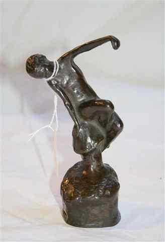 Appraisal: A BRONZE FIGURE of a dancing naked girl high and