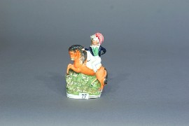 Appraisal: A Staffordshire figure of a boy on a pony