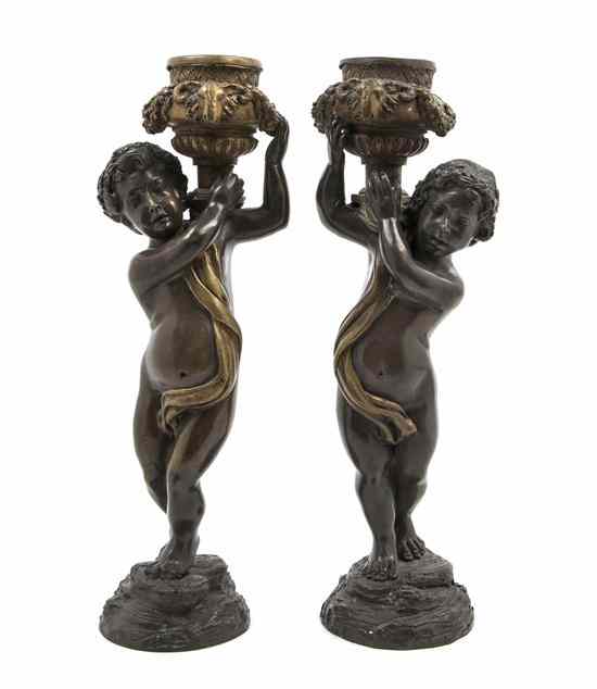 Appraisal: A Pair of Continental Bronze Figural Candlesticks each cast as