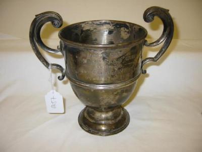 Appraisal: AN EDWARDIAN PRESENTATION TROPHY of ovoid form with scroll loop