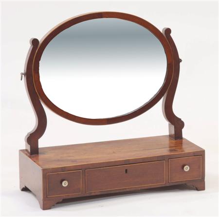 Appraisal: A th century mahogany dressing glass the oval frame enclosing