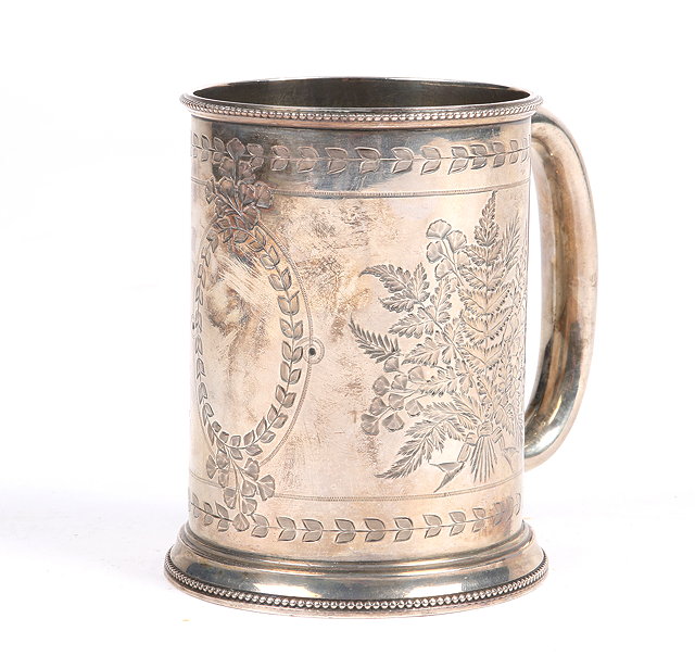 Appraisal: A VICTORIAN SILVER TANKARD of tapering form engraved with bunches