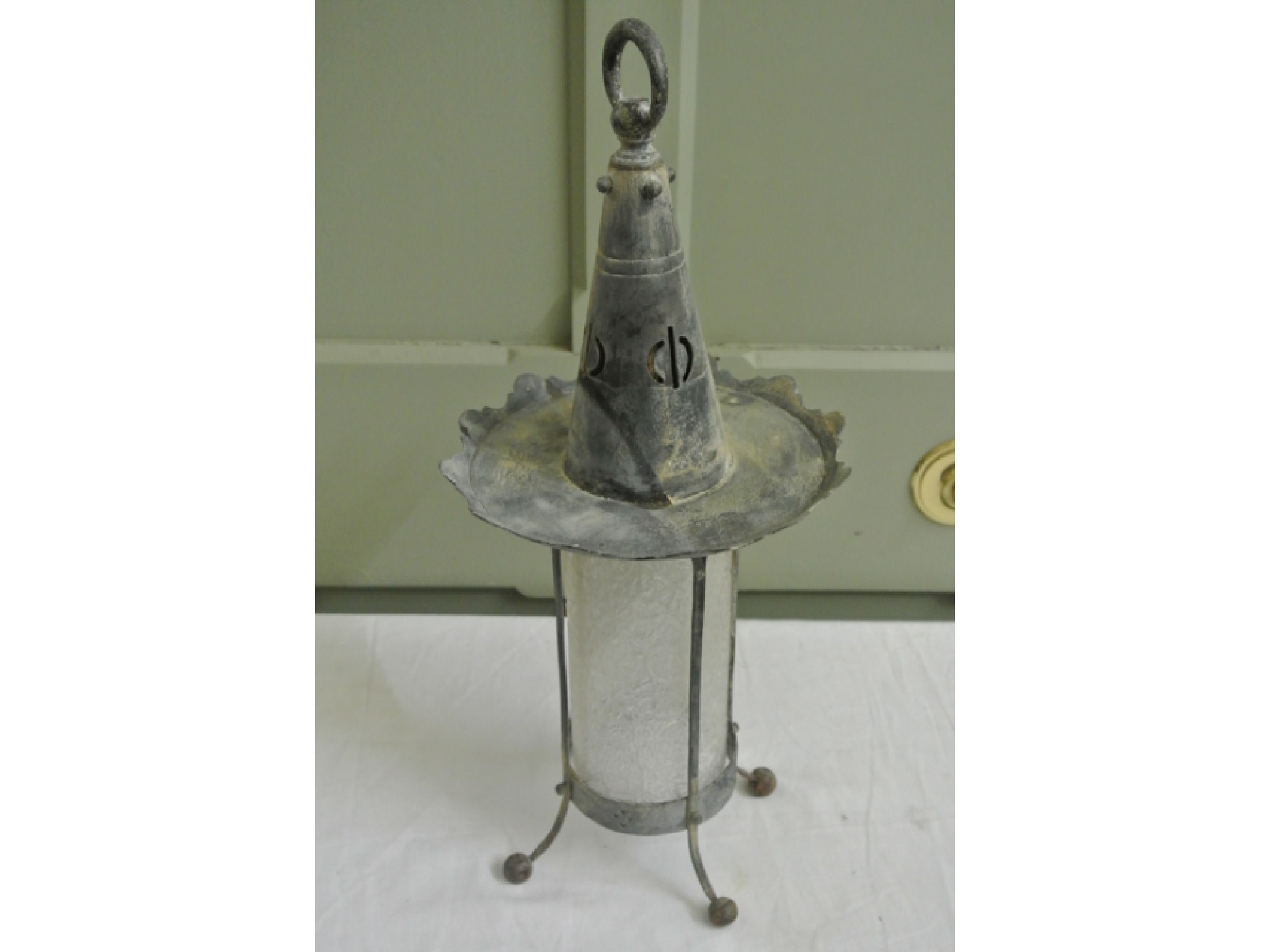 Appraisal: An Arts and Crafts hanging porch lantern the textured cylindrical