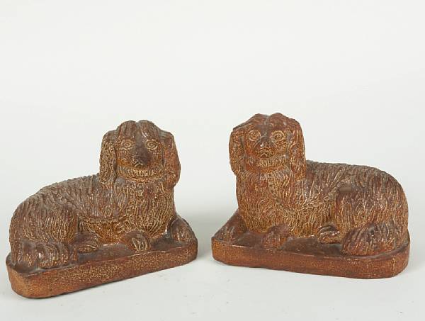 Appraisal: A pair of English salt glazed earthenware spaniels signed 'John