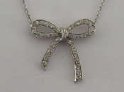 Appraisal: A platinum and diamond bow pendant set overall with small