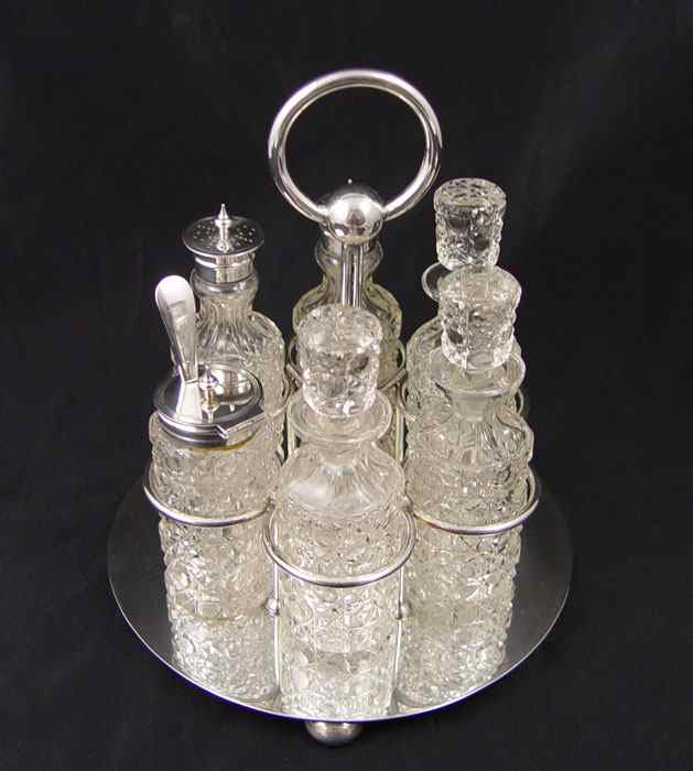 Appraisal: CRUET STAND WITH CUT GLASS BOTTLES HWL silverplated stand condiment