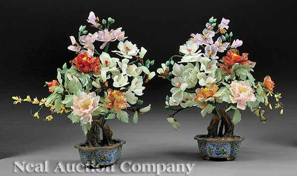 Appraisal: A Pair of Chinese Carved Hardstone Flowering Trees Set within