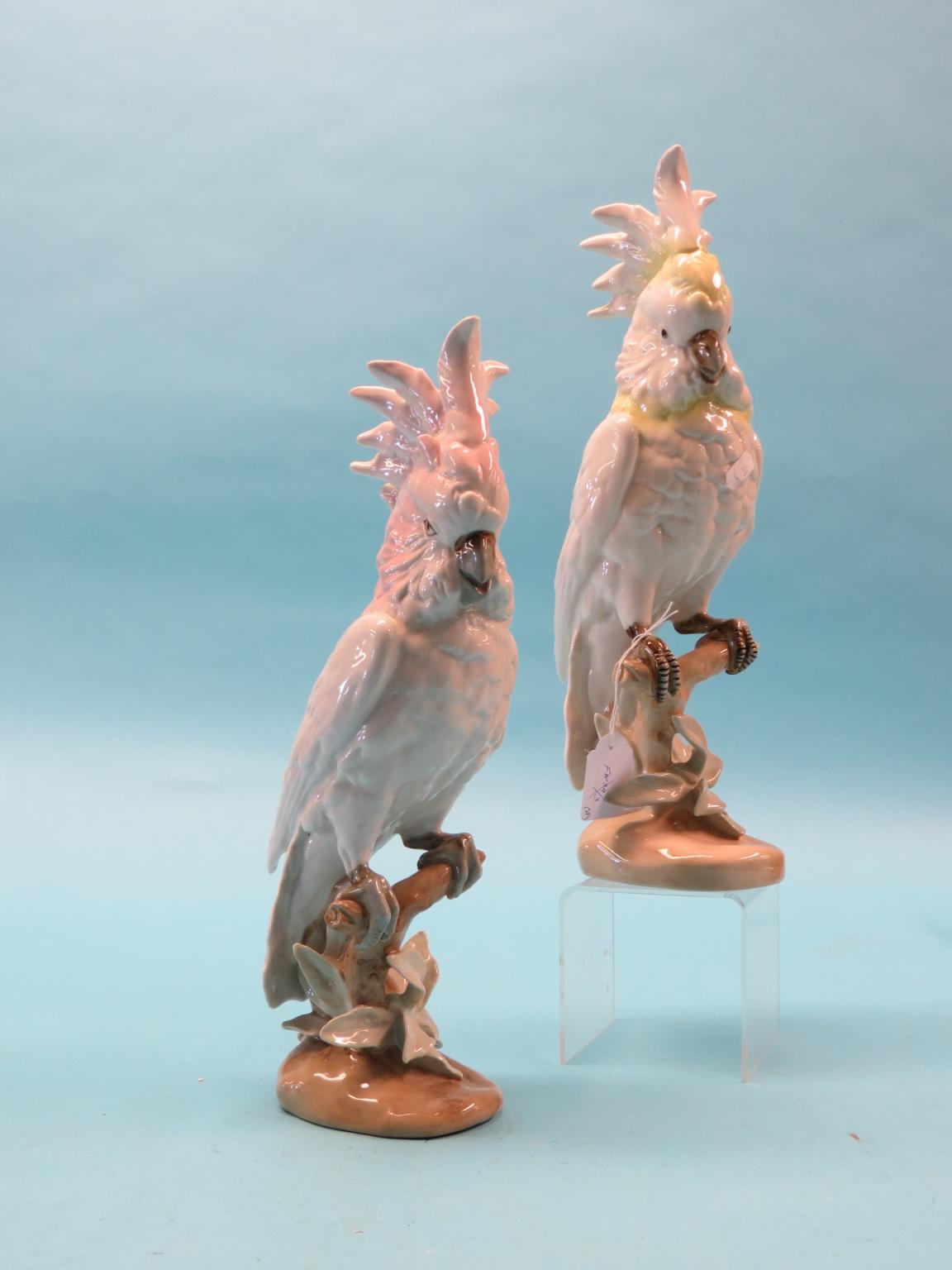 Appraisal: A pair of Royal Dux-style porcelain parrot models perched upon