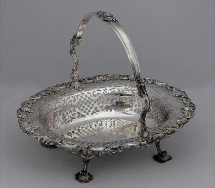 Appraisal: GEORGE II ARMORIAL CAKE BASKET Edward Aldrige London the oval