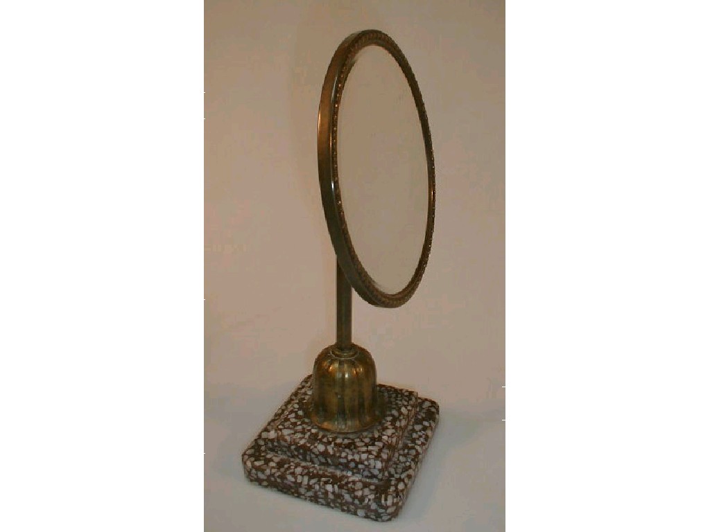 Appraisal: A pedestal mirror the circular bevelled plate on a brass