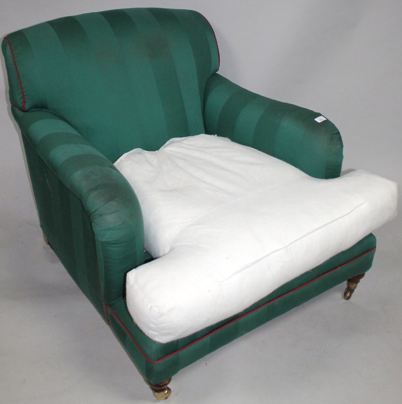 Appraisal: An Edwardian deep seated armchair upholstered in later green striped